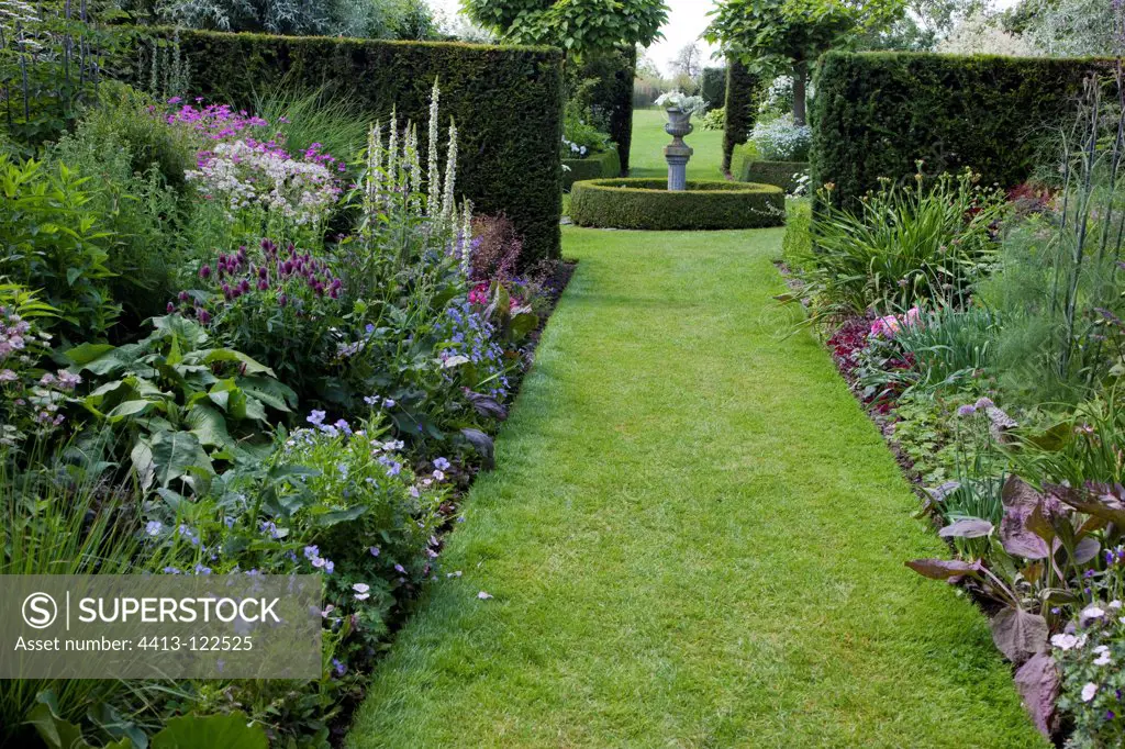 Turf garden path and mixed-borders in a garden
