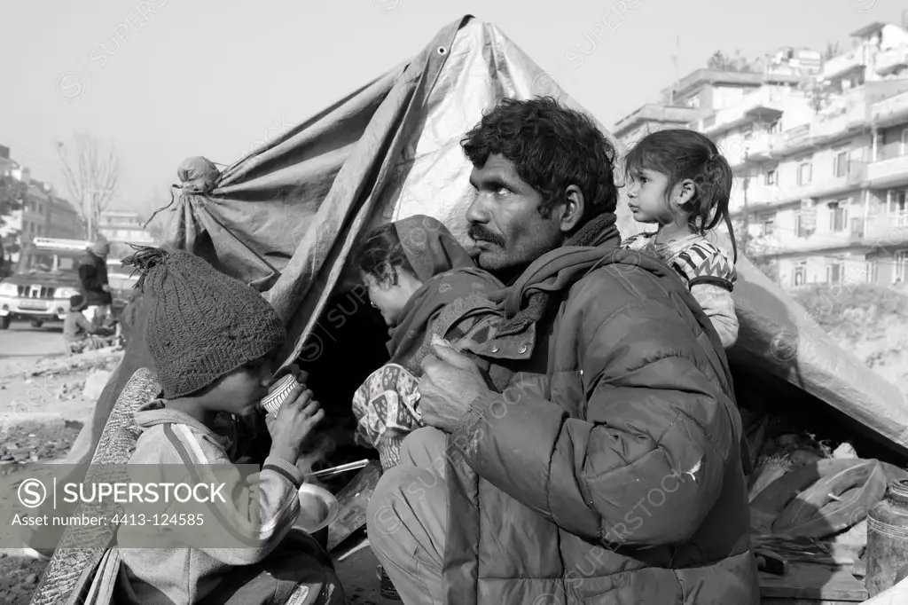Family eating outside his tent Kathmandu Nepal