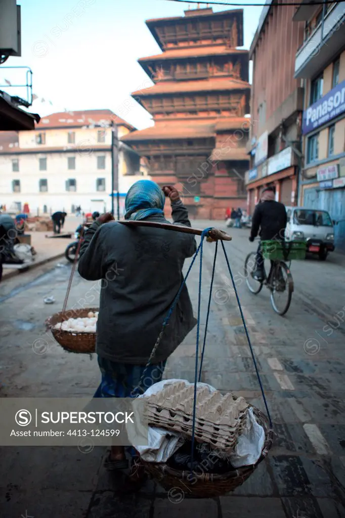 Woman carrying baskets of eggs in Kathmandu Nepal