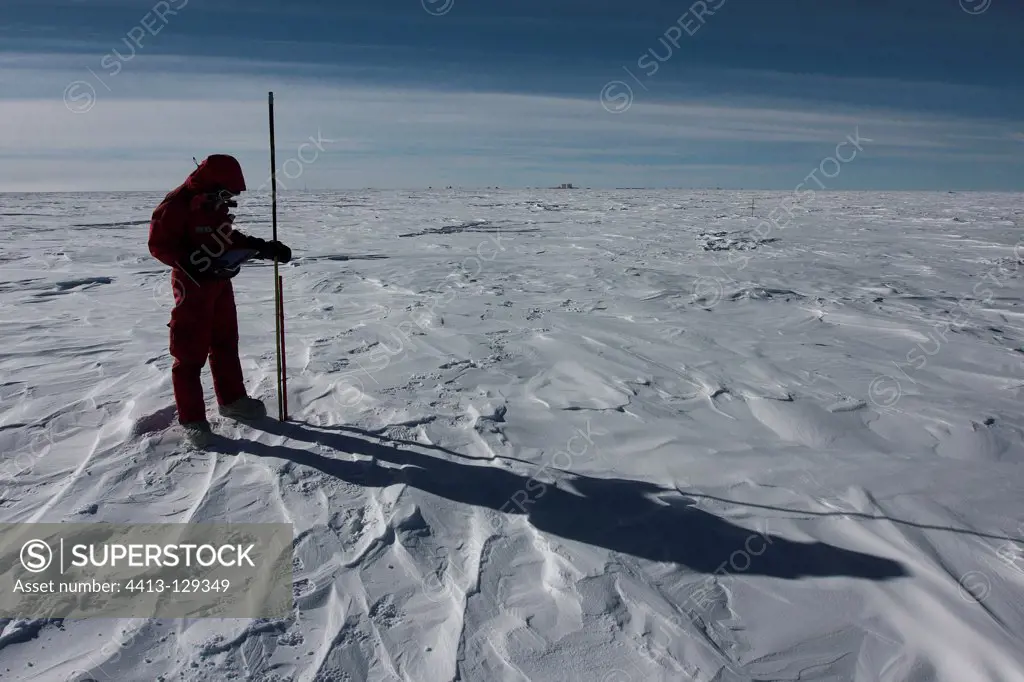 Glaiologue measuring snowfall Concordia Antarctic
