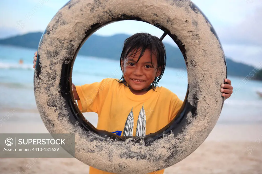Girl playing with a tire Perhentian Kecil Malaysia