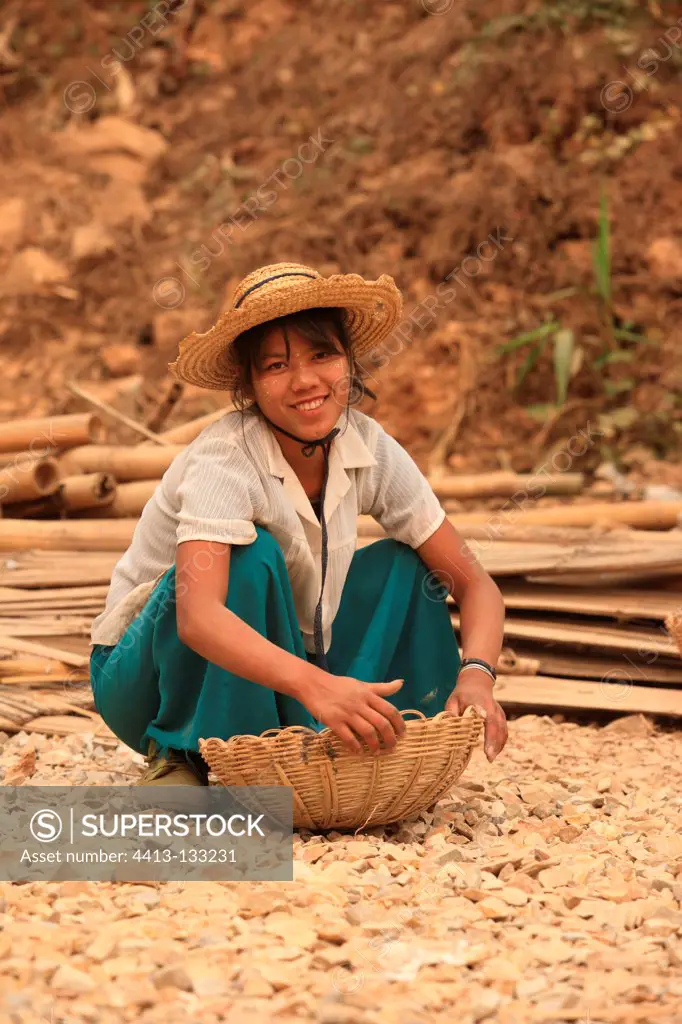 Young woman working on a road project in Burma