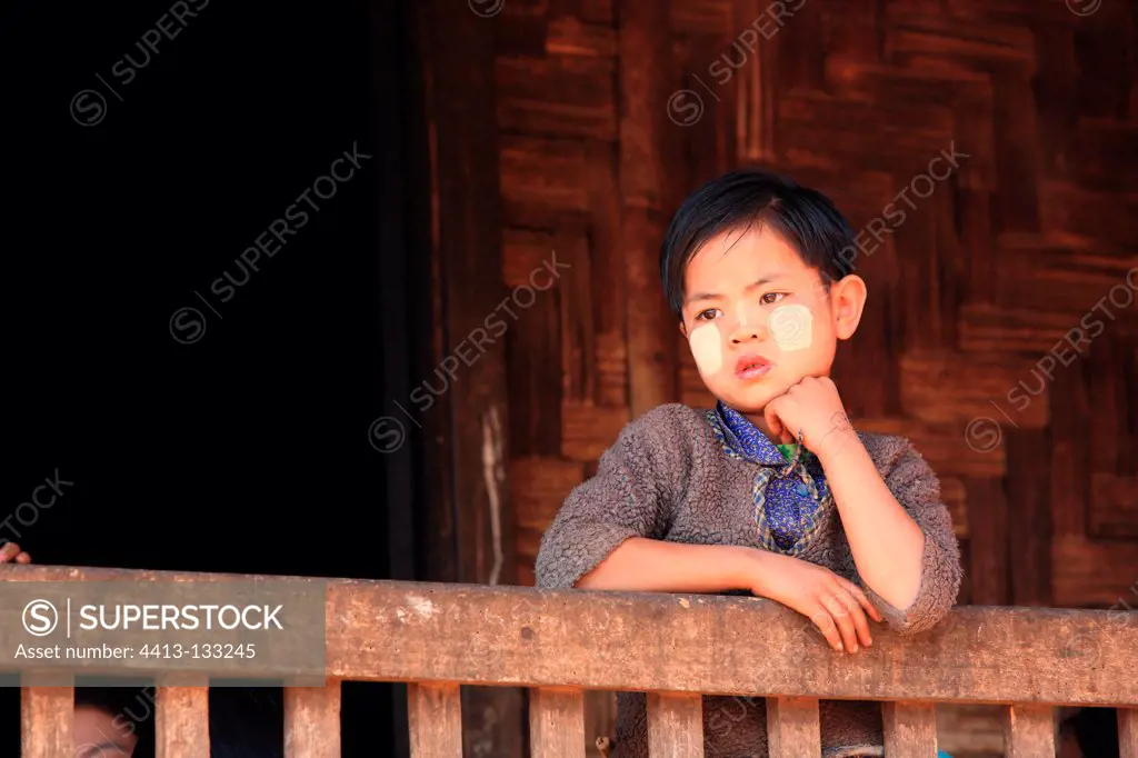 Girl leaning on a railing house Burma