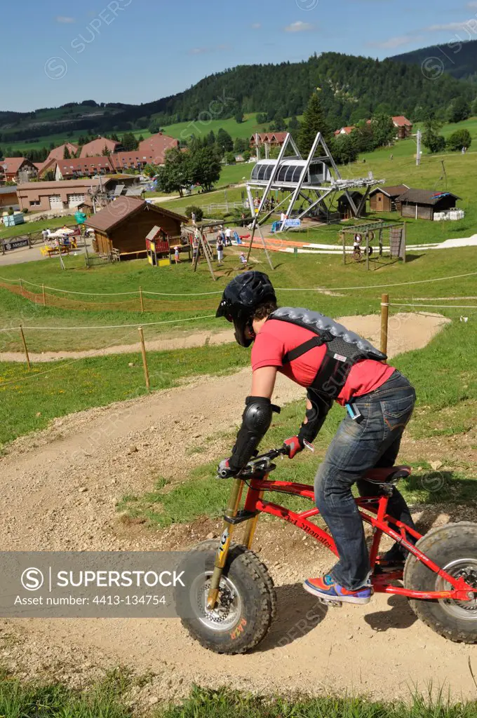Downhill scootering on the ski slopes in summer Jura