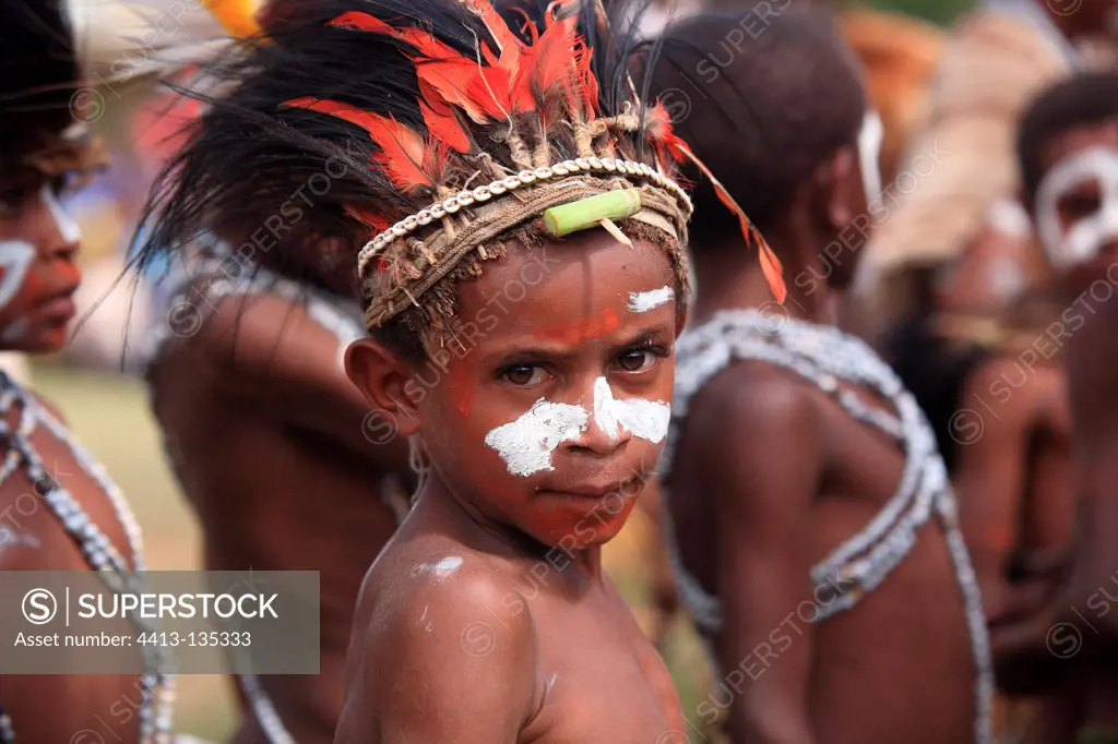 Boy with feather headdress and paint Papua New-Guinea