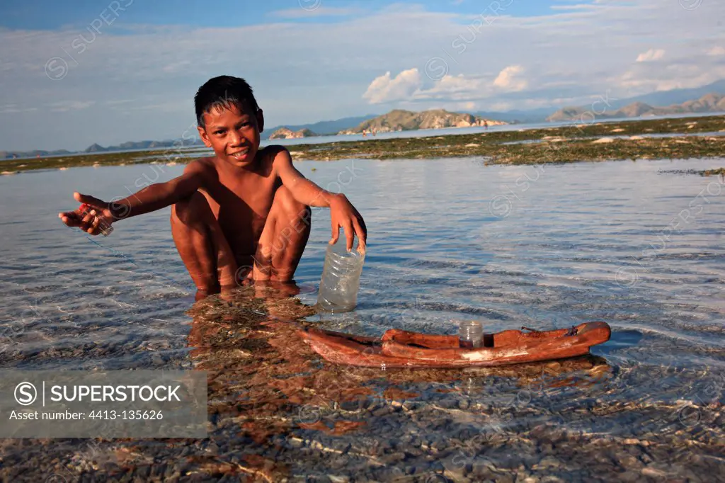 Boy playing with a boat Messah Pulau Flores Indonesia