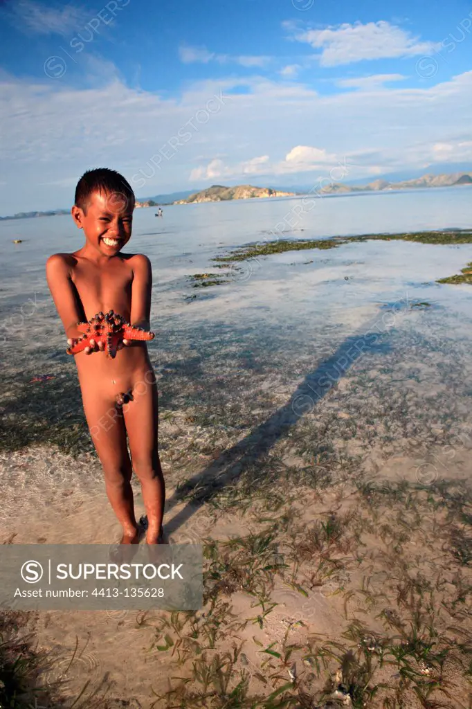 Boy with Starfish Messah Pulau Flores Indonesia