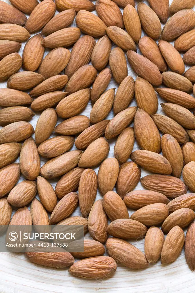 Almonds arranged on a wooden tray