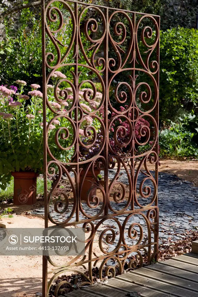 Wrought iron gate in an organic kitchen garden