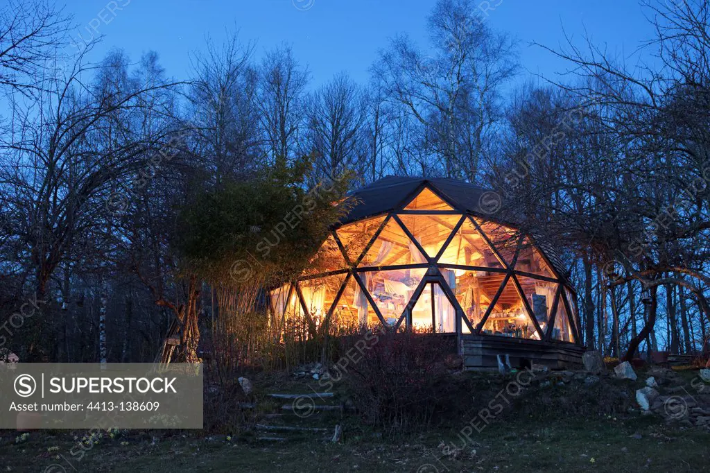 Geodesic shaped ecohouse by night in Ariège France