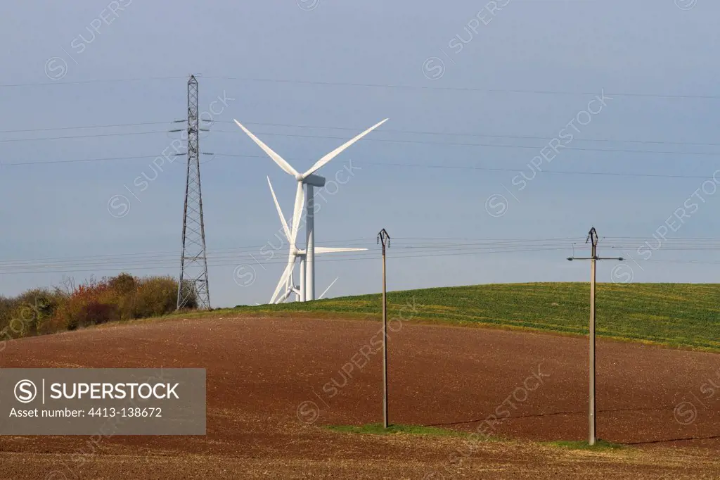 Windmills in the countryside and power lines Lorraine France