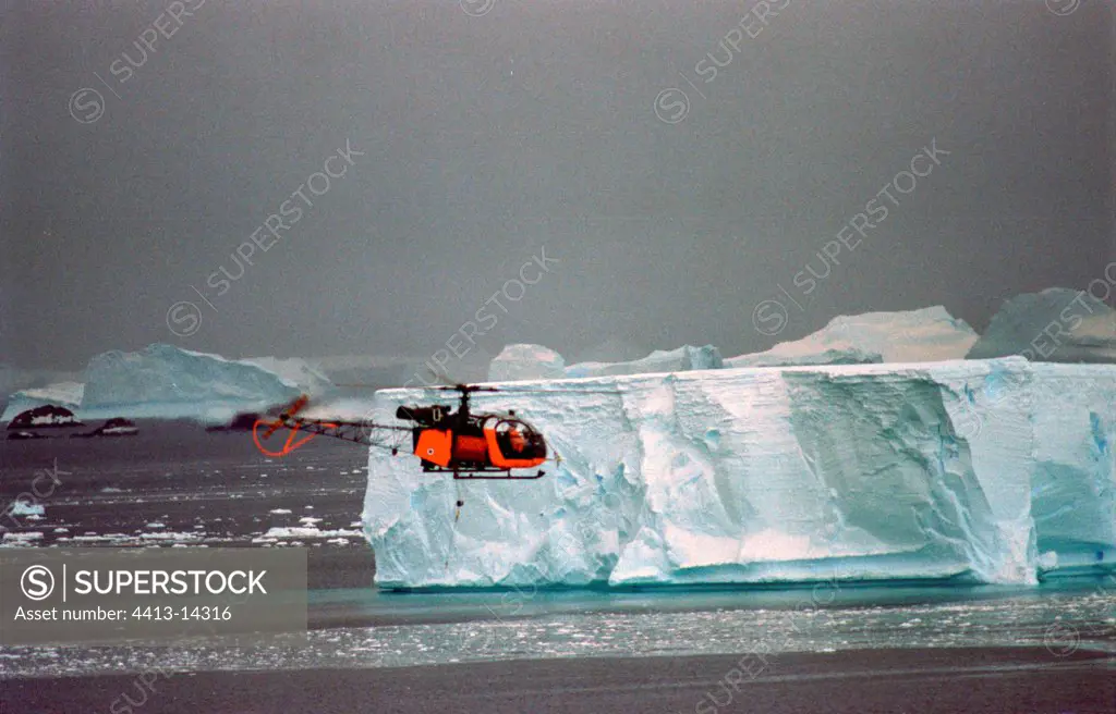 Military helicopter flying over of the icebergs