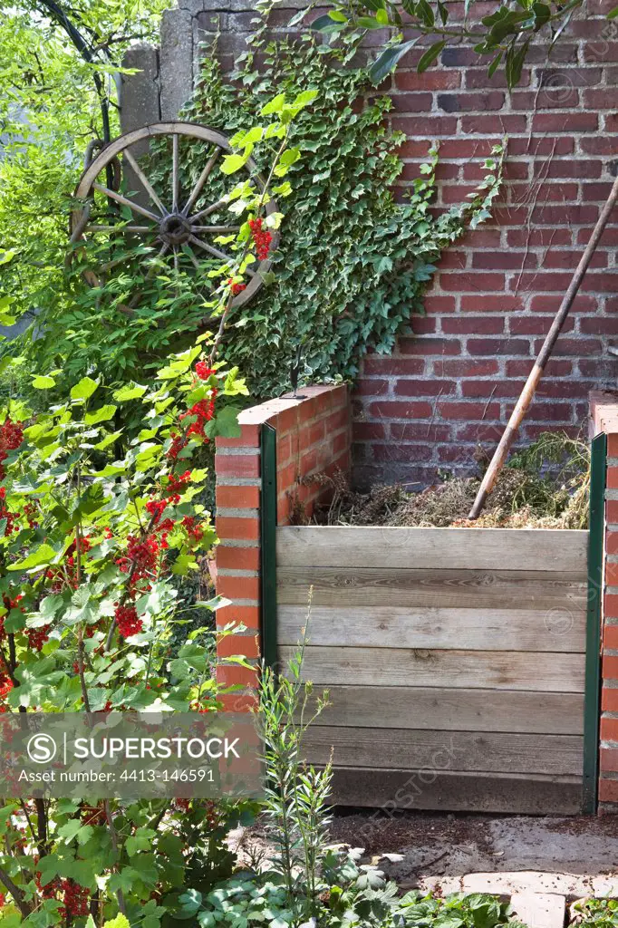 Brick ompost container in a kitchen garden