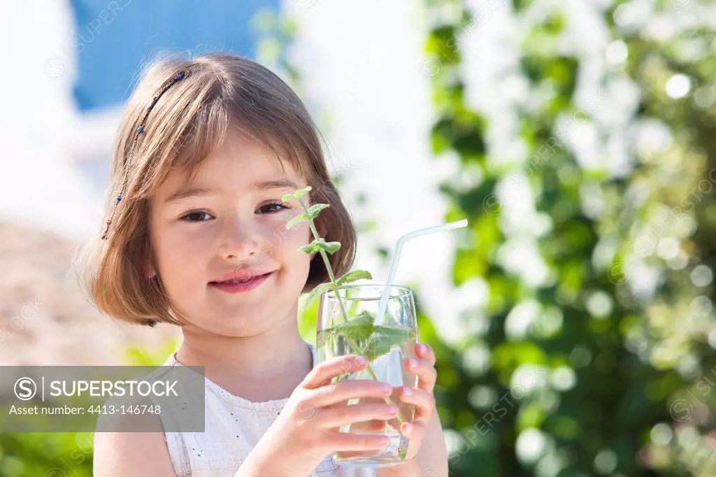 Little girl drinking a mint drink