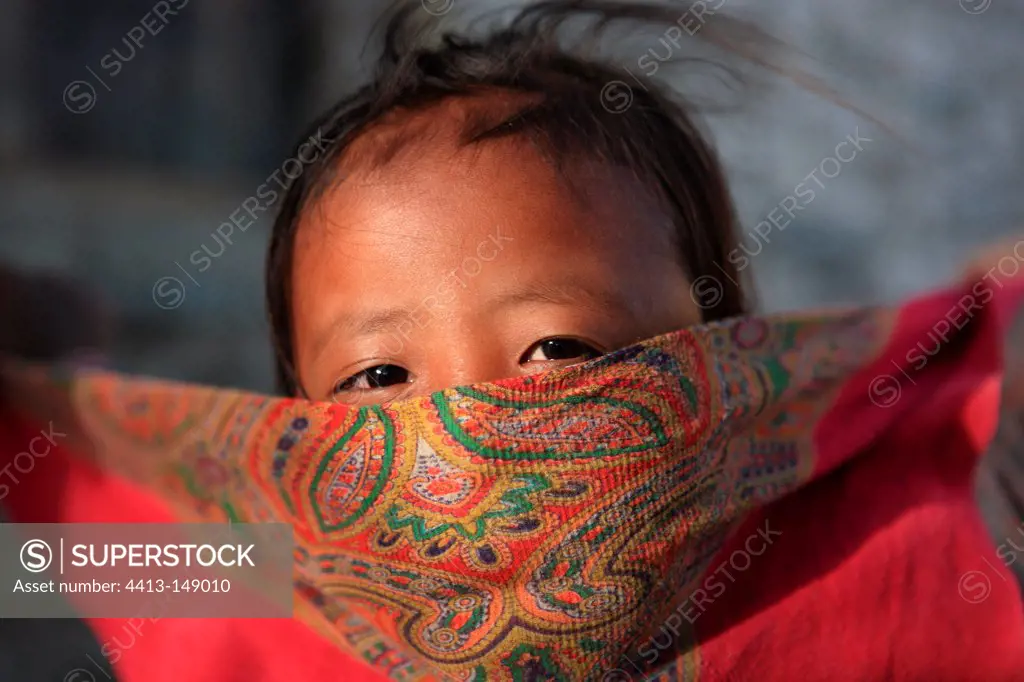 Portrait of a girl playing with a scarf India