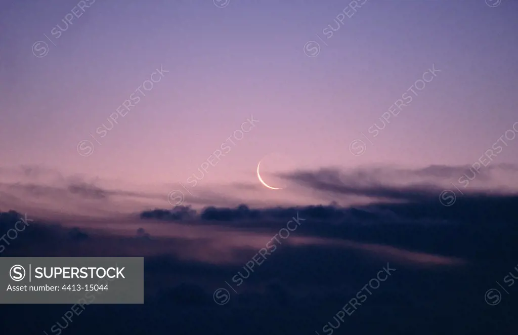 Crescent of Moon through the clouds France
