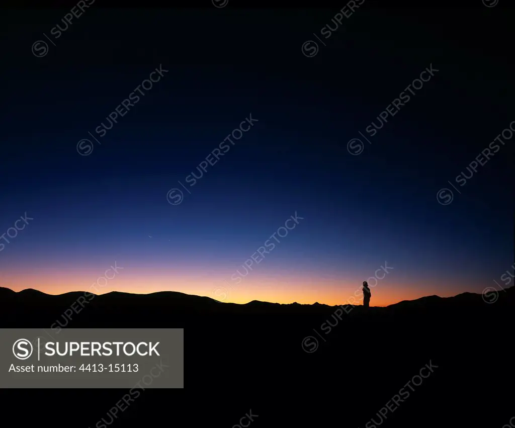 Man observing a moon rising in conjunction with Venus