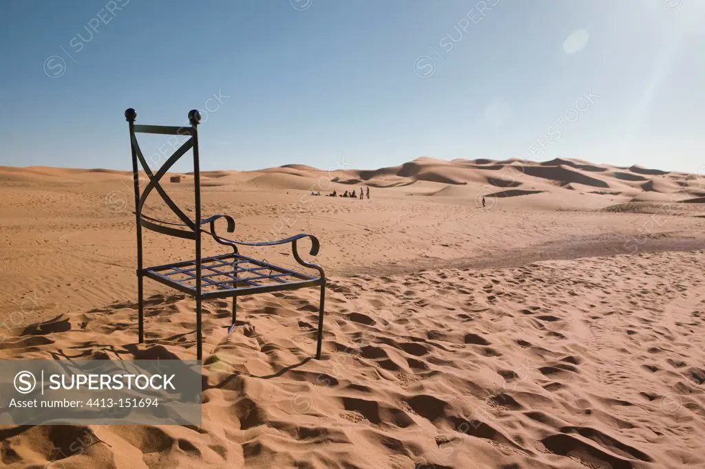 Wrought iron chair in the sand dunes of Merzouga