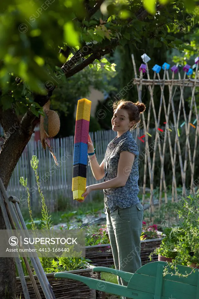 Young girl playing with pots in a kitchen garden