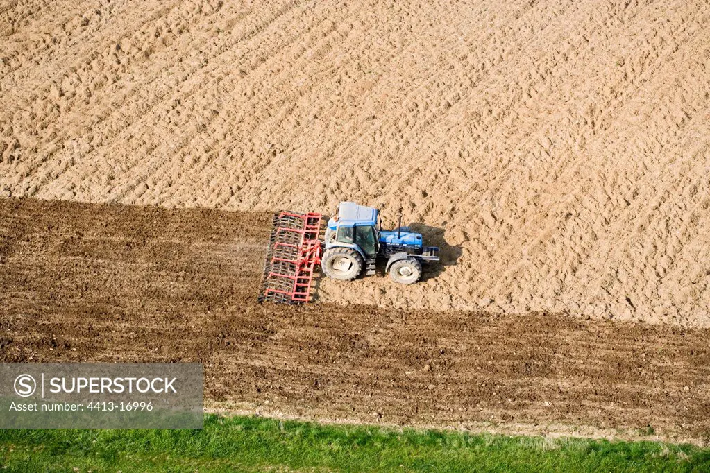 Air shot of the passage of the heavy harrow in a field