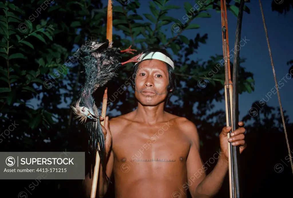 Matses Tribesman hunter with a piping guan Peru