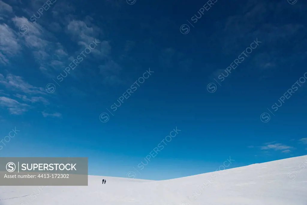 Hikers in the snow on the island Ammassalik Greenland