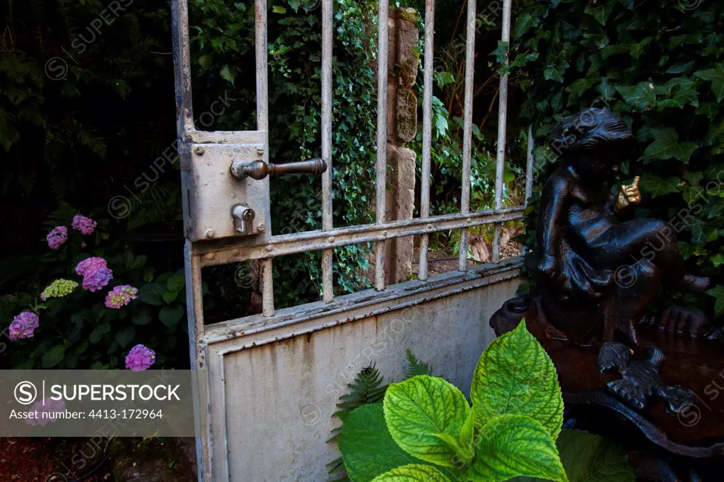 Bird bath and gate in a garden