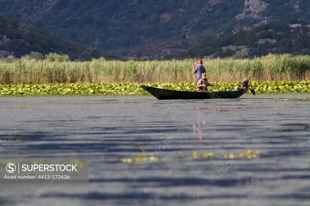 Fishermen in a boat in the NP of Skadar lake Montenegro