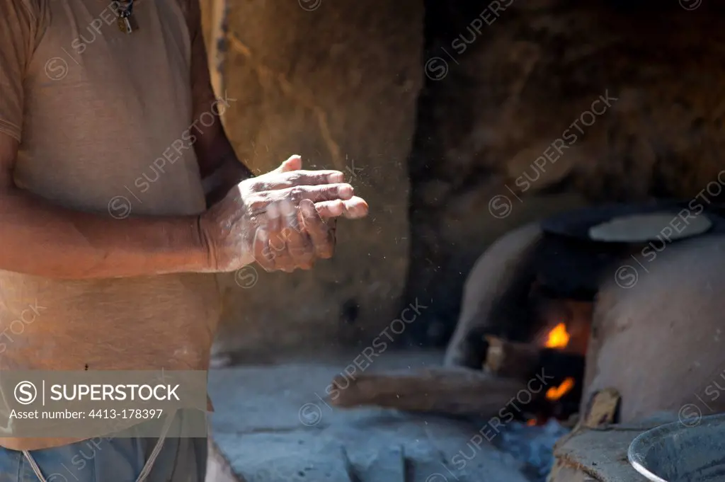 Indian flatbread baker kneading the dough