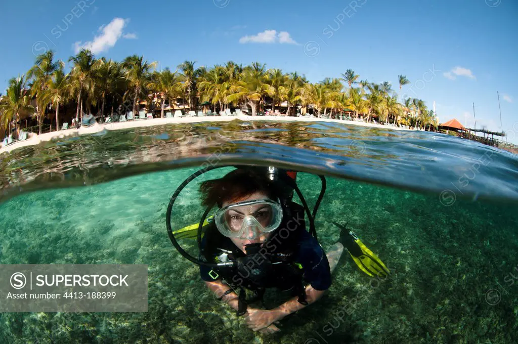 Diver on the beach of the resort Harbour Village in Bonaire