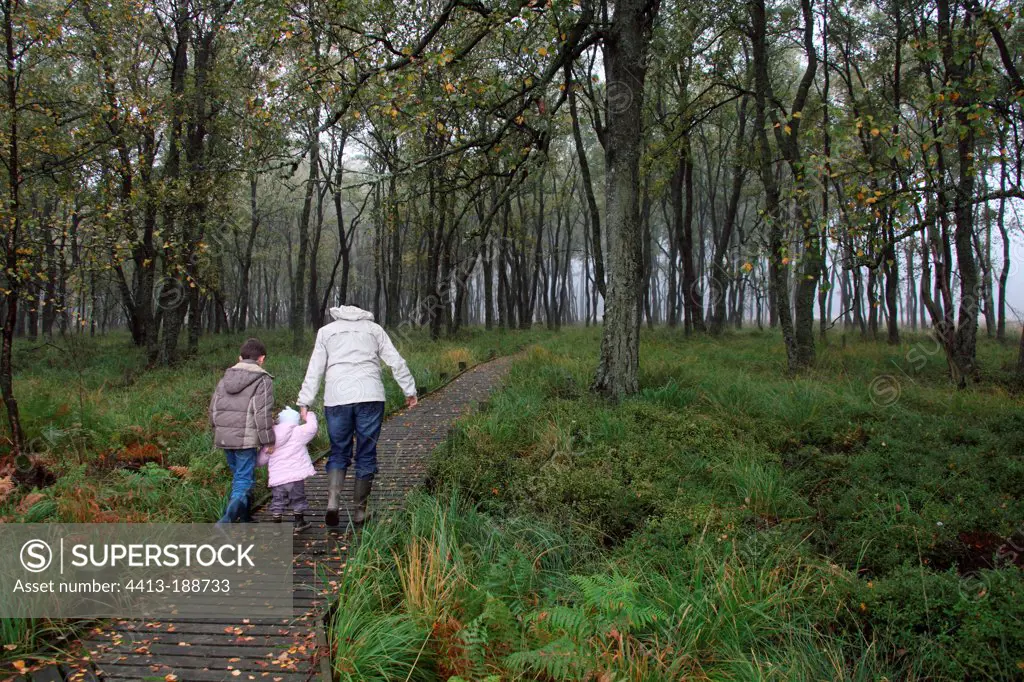 Family walking in a forest in Belgium