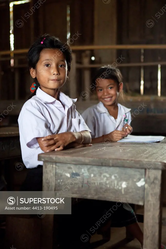 Girls behind their desks in a school in Laos