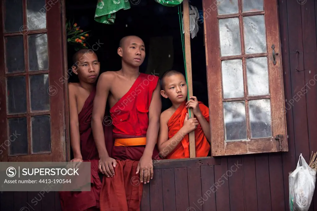 Novice monks looking out the window in Nyaung Shwe Burma