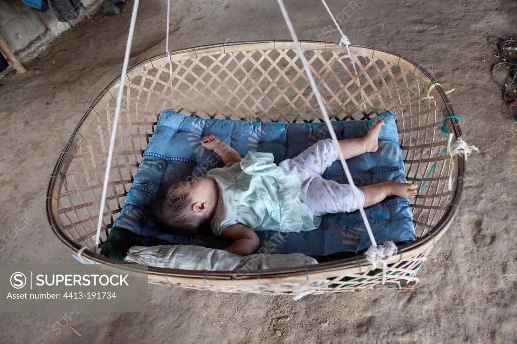Baby taking a nap in a hammock bamboo in Laos