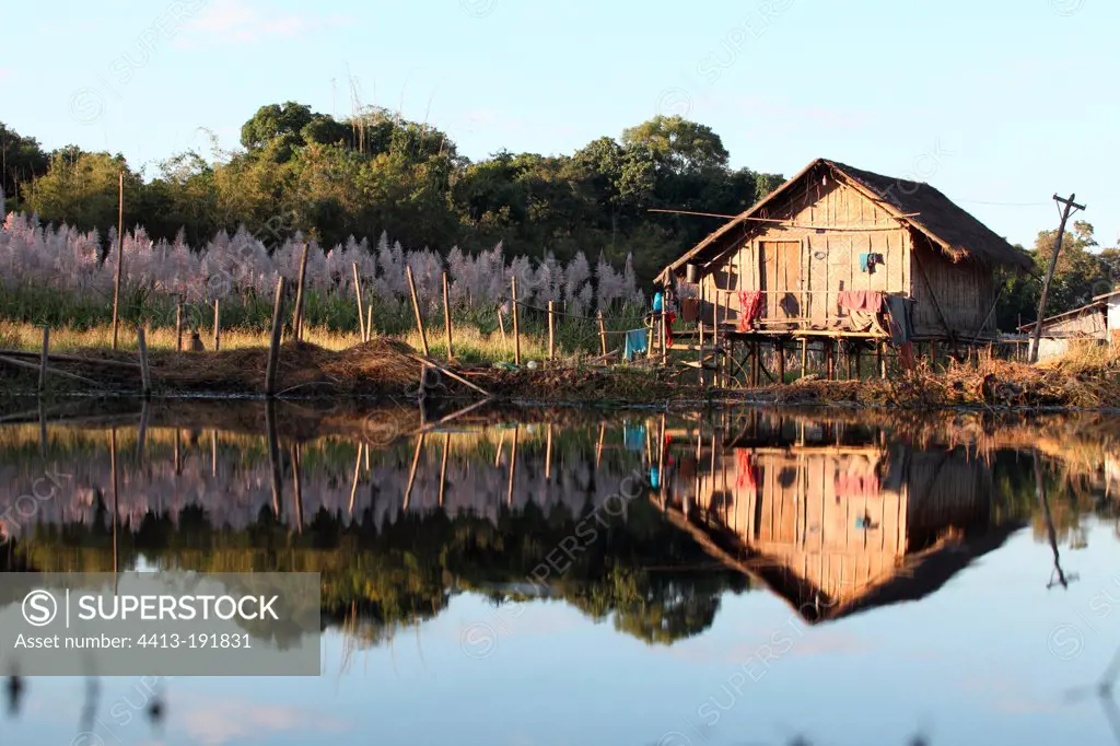 Bamboo House reflected in Inle Lake in Burma