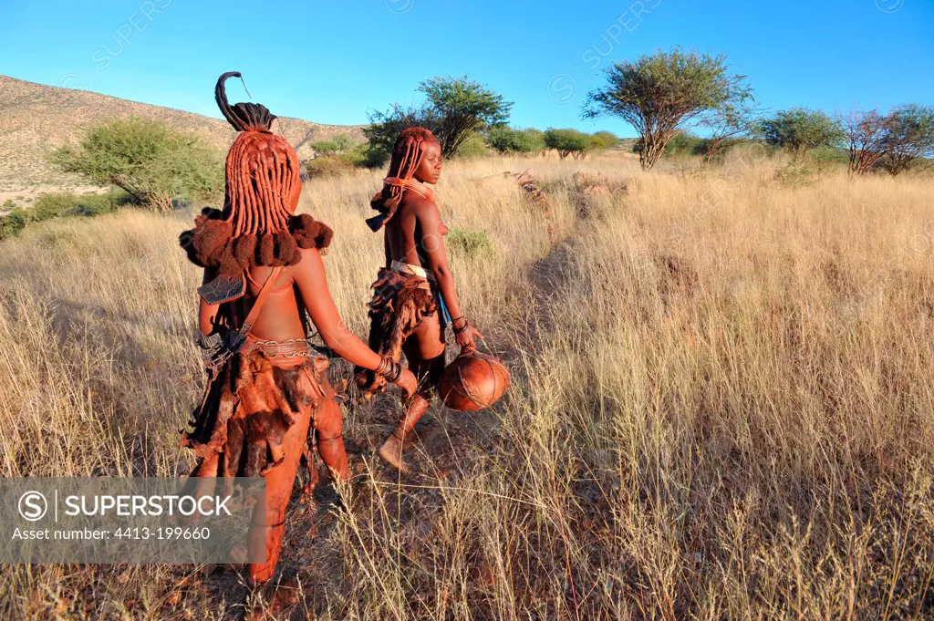 Women himbas fetching water in Namibia