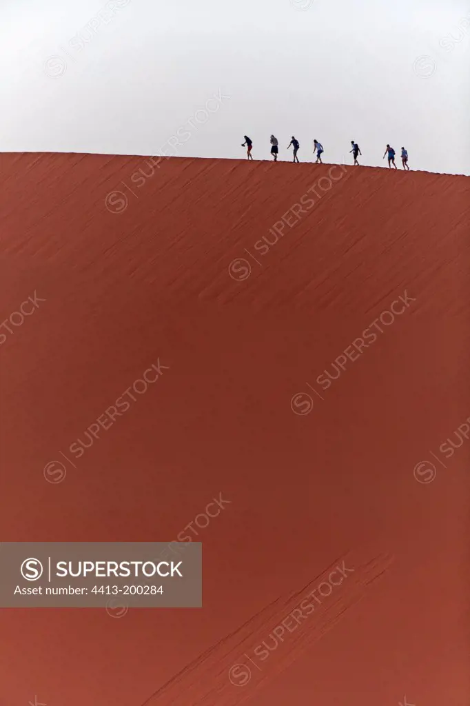 Tourists on a sand dune in Namib Desert Namibia