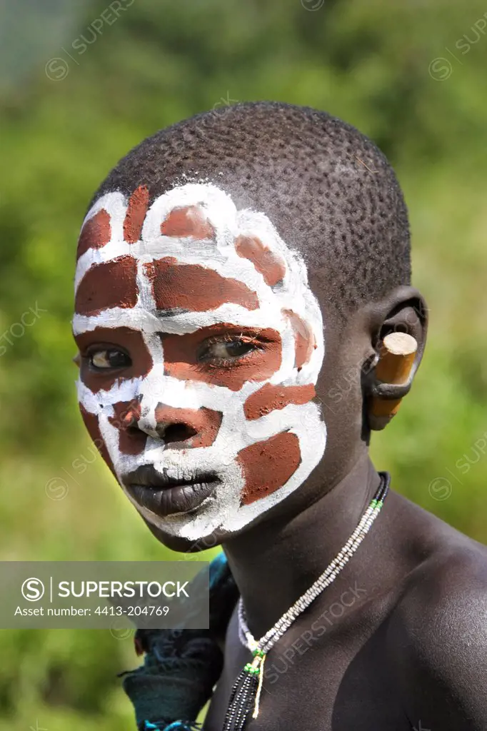 Portrait of a Surma child with face ritual paintings