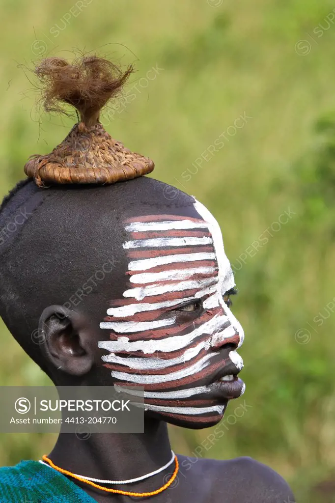 Portrait of a Surma child with face ritual paintings