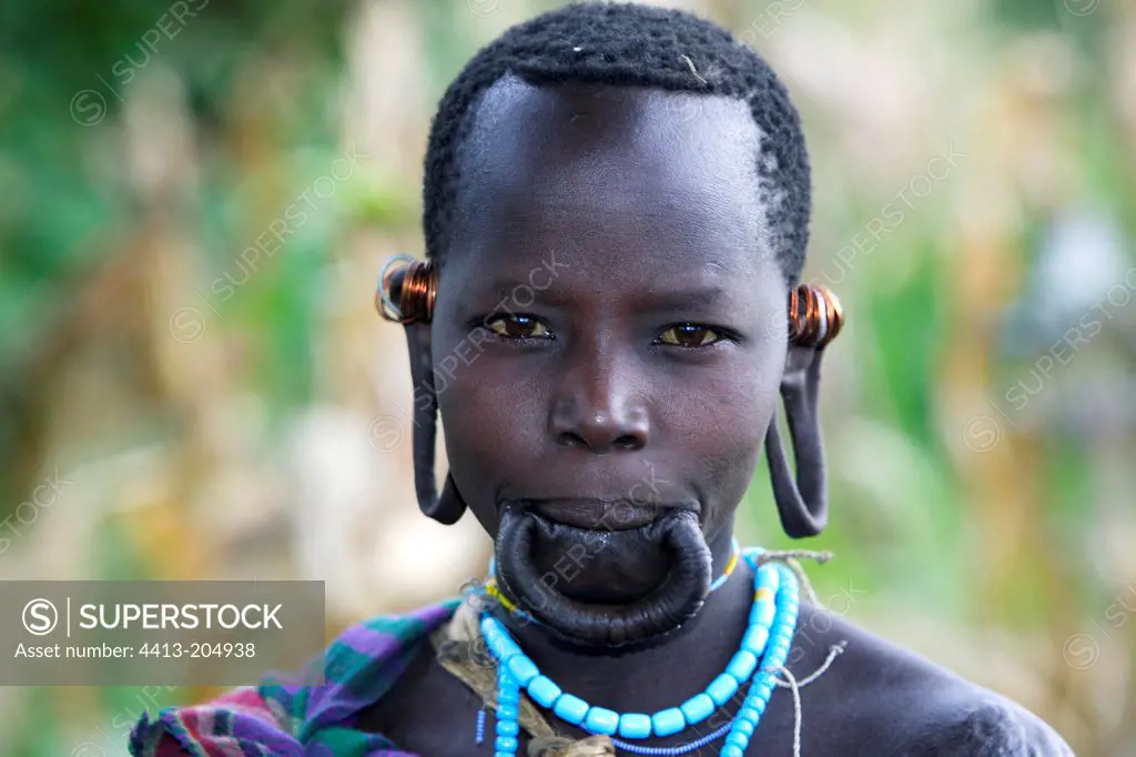 Portrait of a Surma woman with stretched lip and earlobes