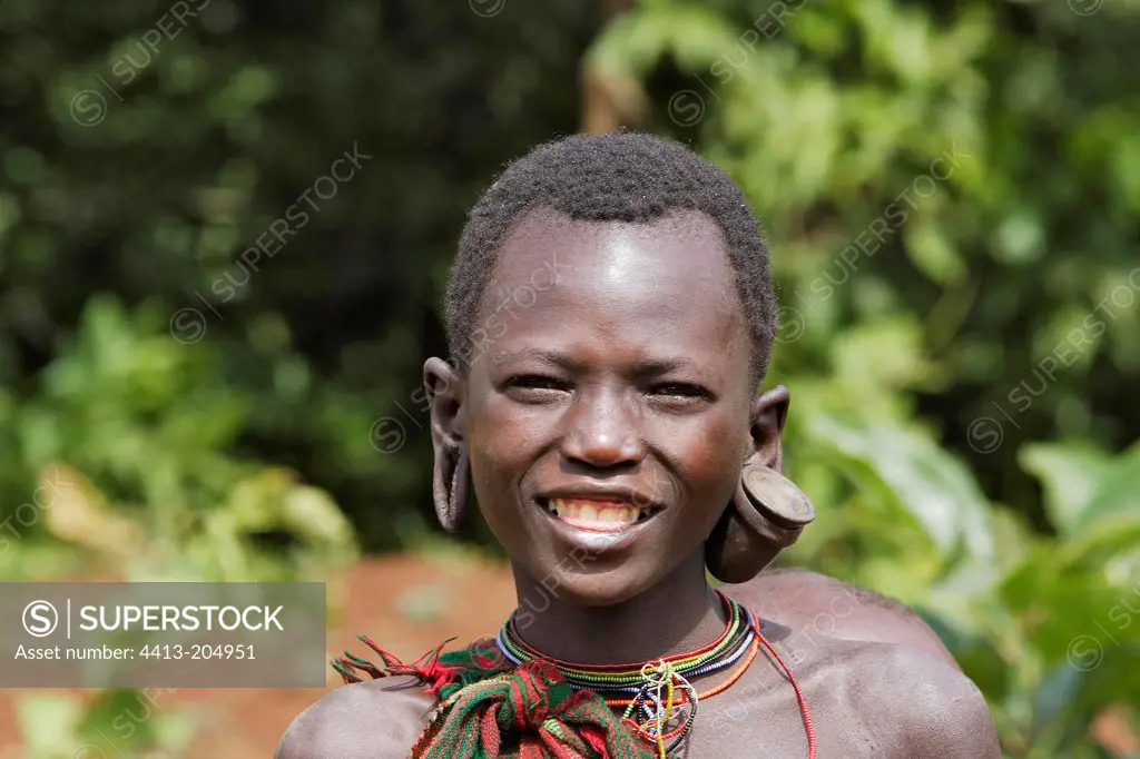 Portrait of a smiling Surma girl Ethiopia