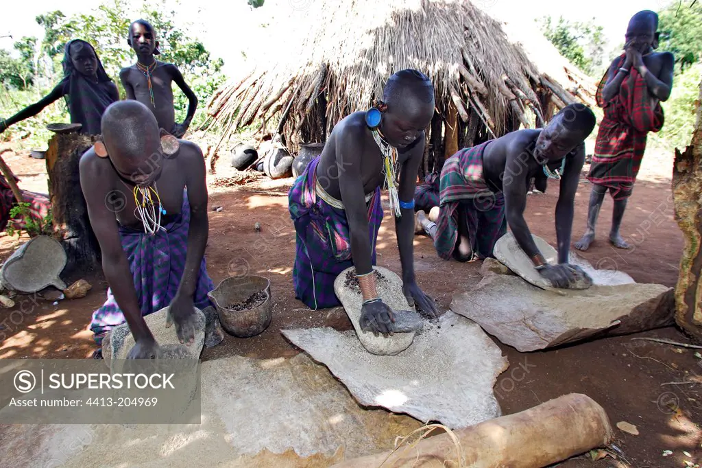 Surma women grinding corn Ethiopia