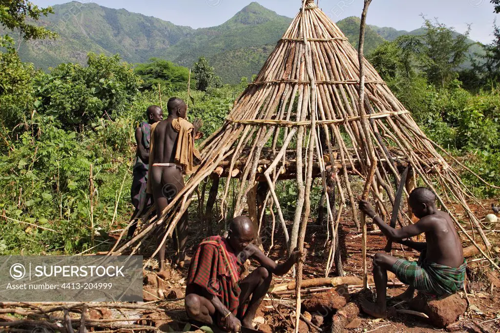 Surma men building a hut Southwestern Ethiopia