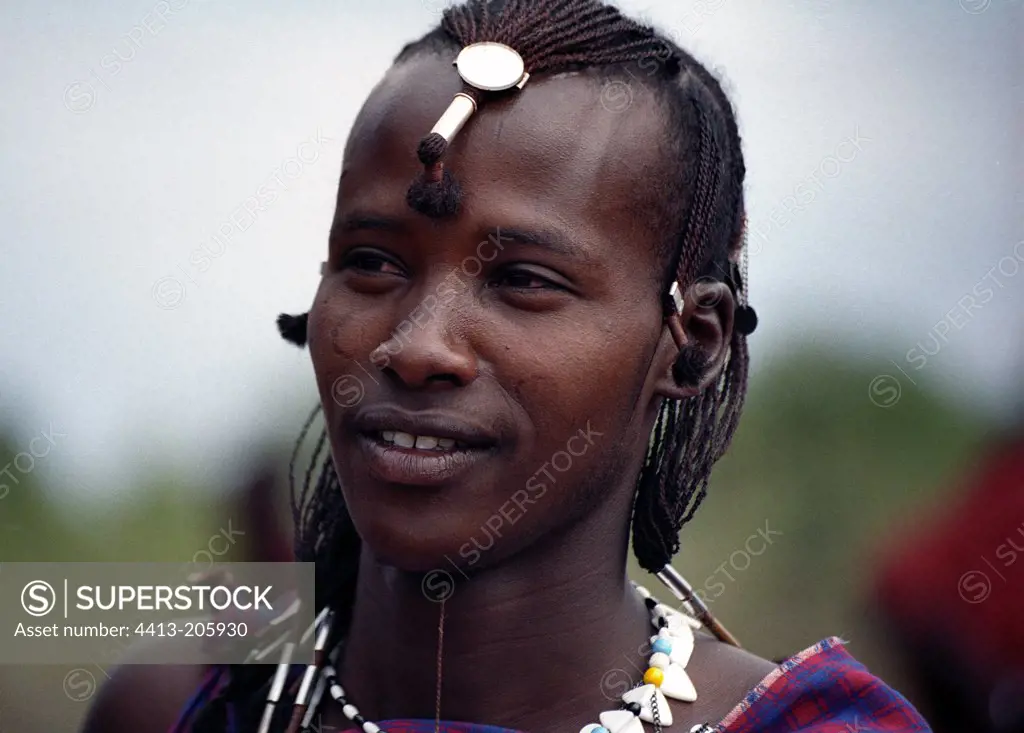Young Maasai warrior bearing the traditional hairdos