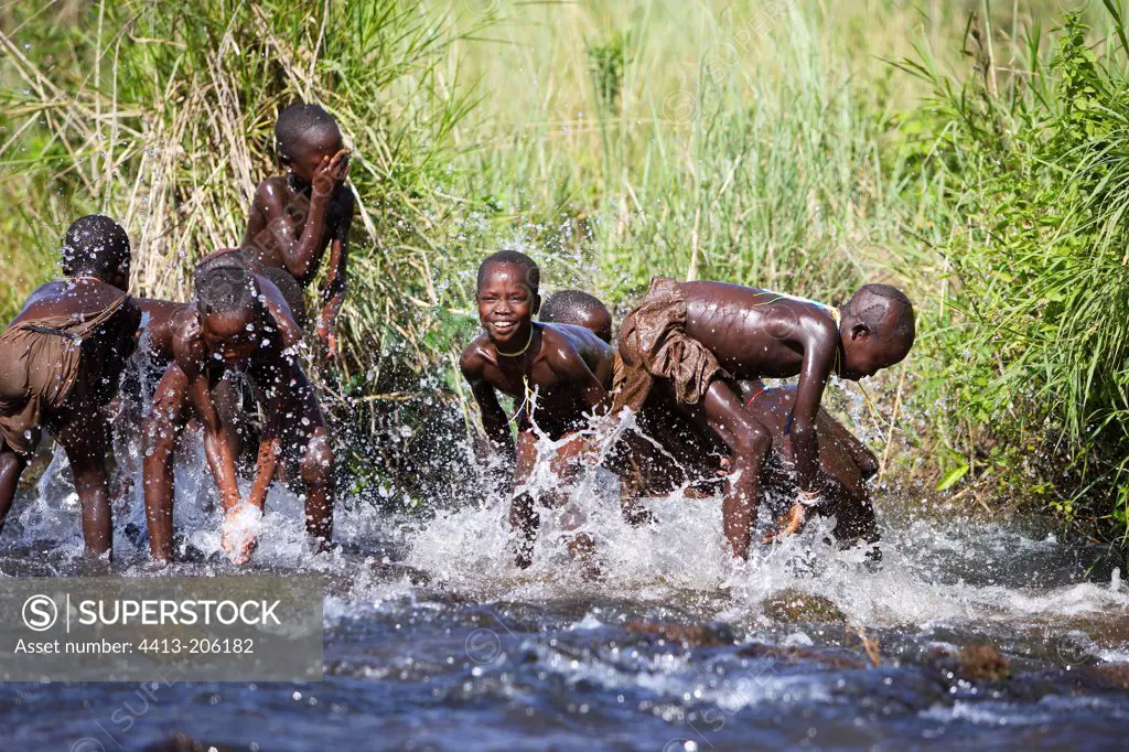 Surma children playing in the water Ethiopia