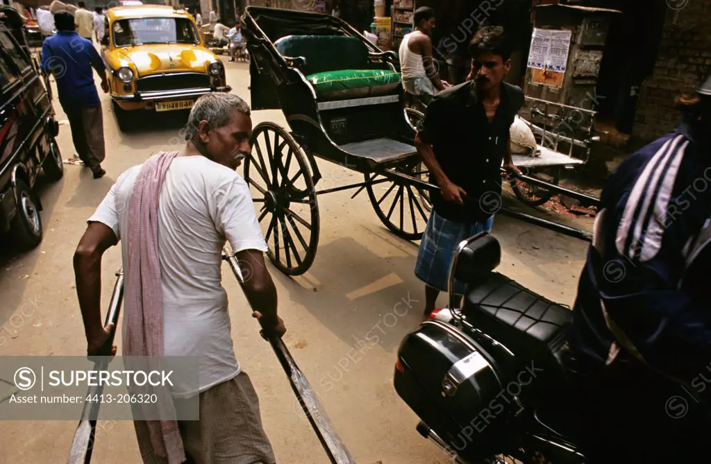 Rickshaws and taxi on the streets of Calcutta India