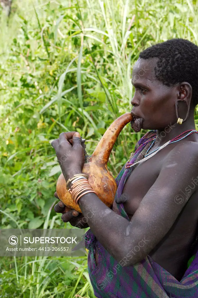 Surma woman smoking with a calabash Ethiopia