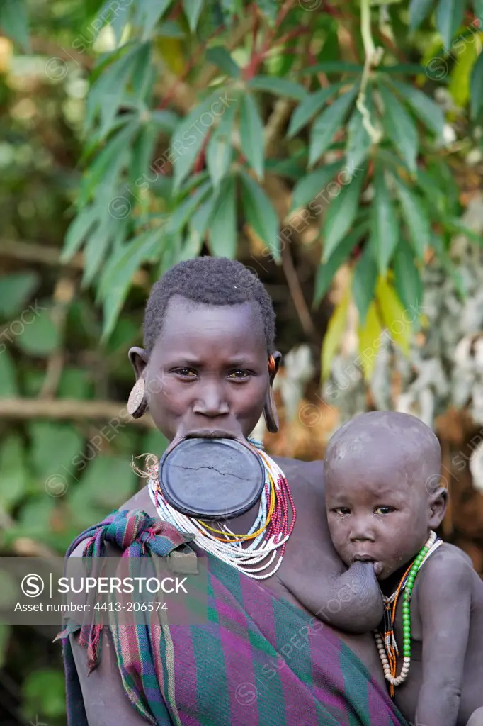 Portrait of a Surma woman holding her child Ethiopia