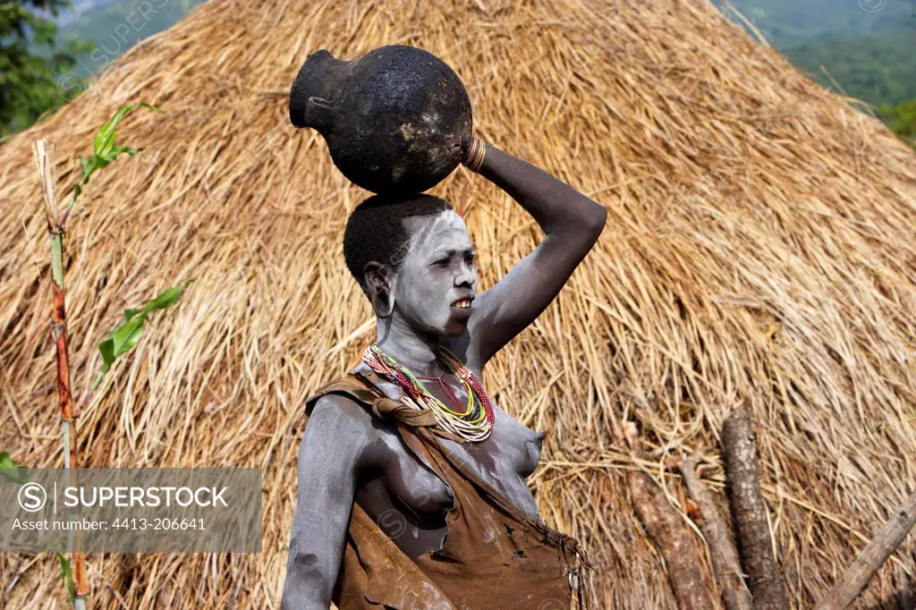 Surma woman carrying a jar on the head Ethiopia