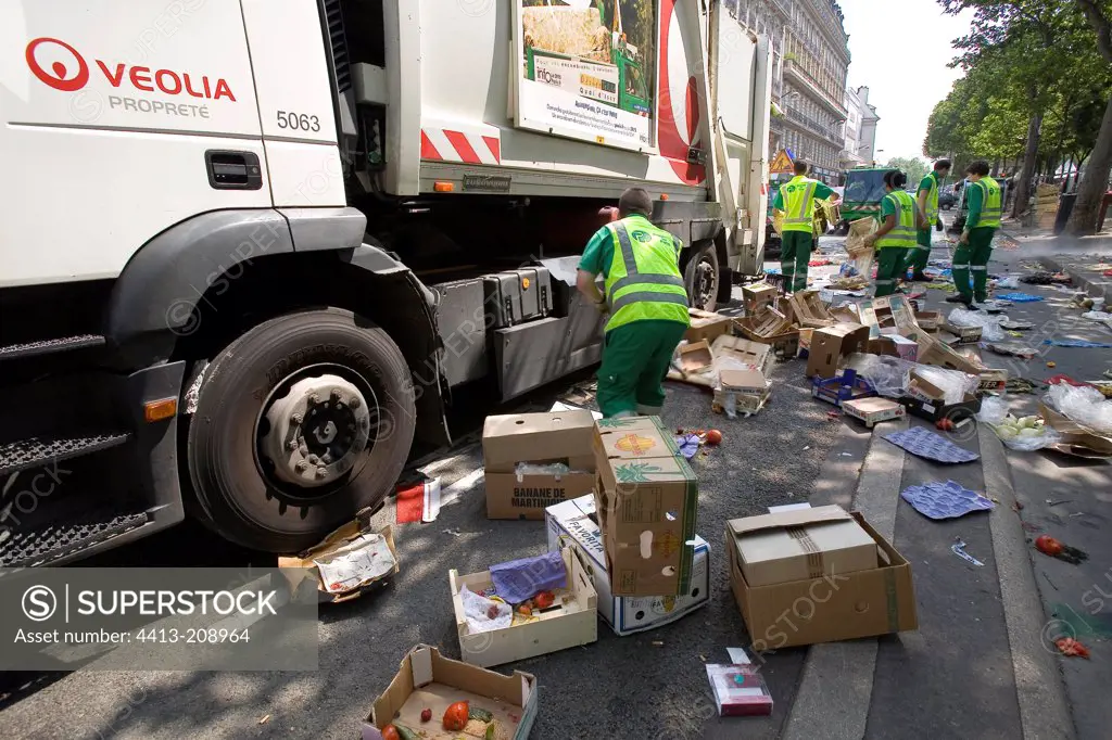 Group of garbage collectors at work on a street in Paris